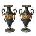Paire de cassolettes décoratives à anses ornées et décors de putti, régule patine verte et dorée