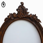 Cadre ovale en bois sculpté massif fronton arabesques + vitre verre