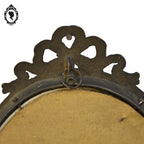 Petit cadre ovale nœud style Louis XV métal doré mural vintage