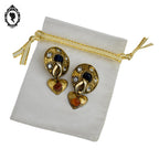 Grosses boucles d’oreilles clips dorées signées Claire Dévé bijou vintage